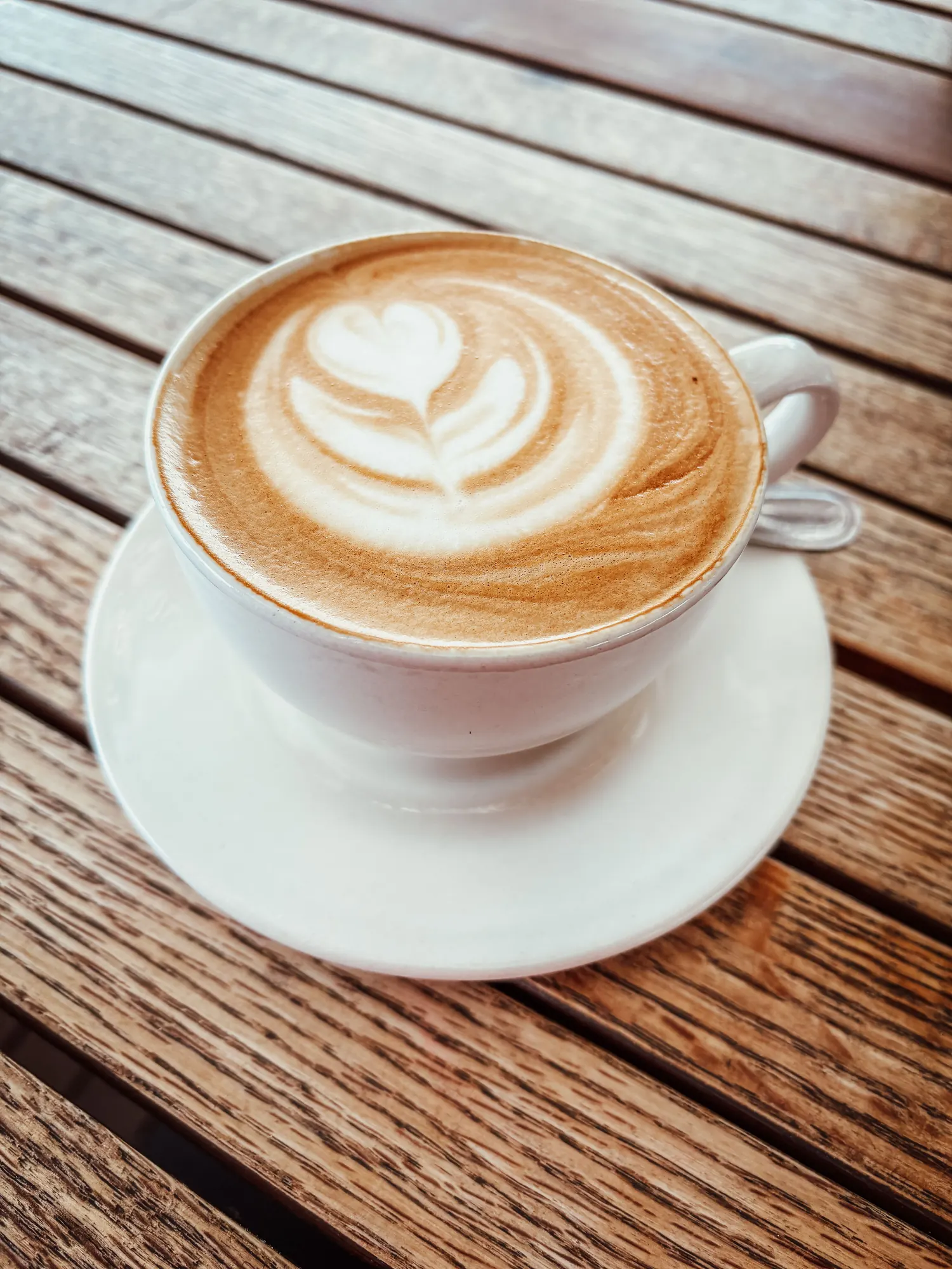 A cappuccino set down on a wooden table