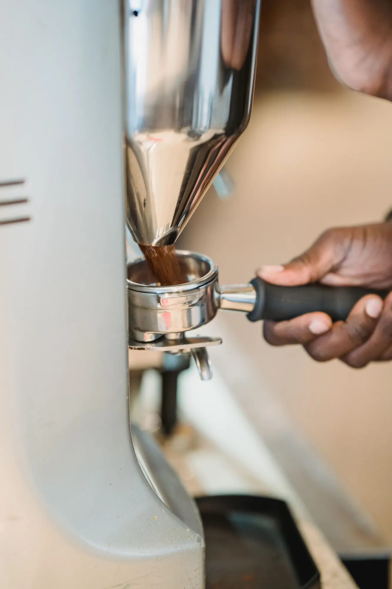 Freshly ground coffee falling into a portafilter