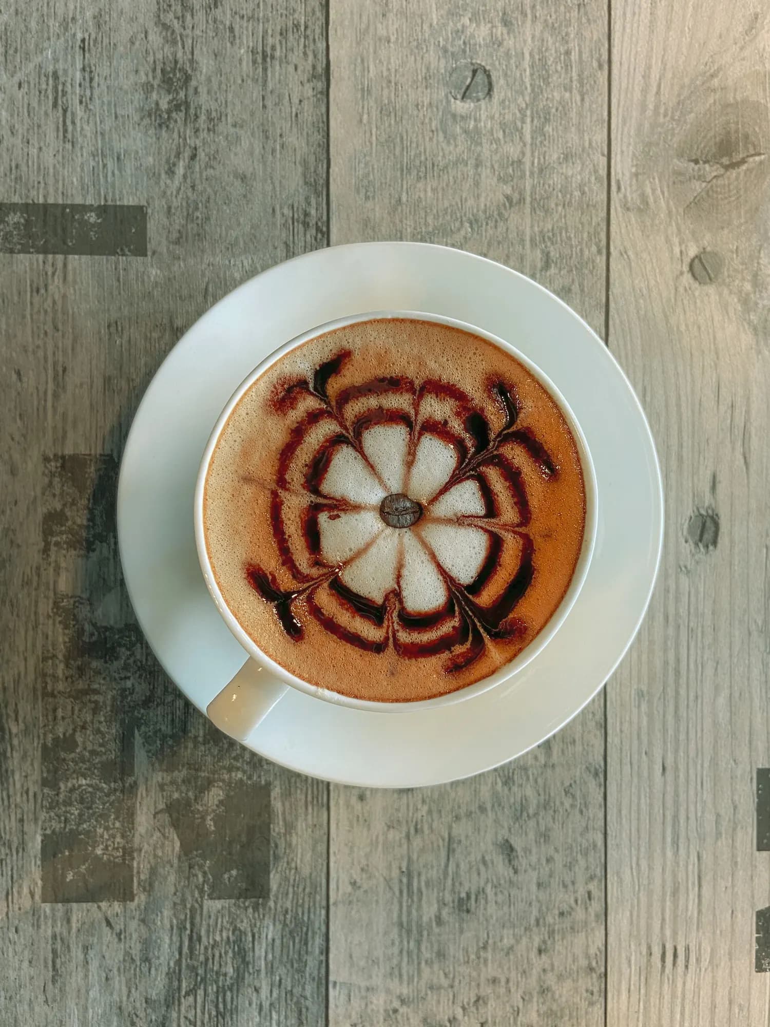 A latte seen from above with poured rosetta art