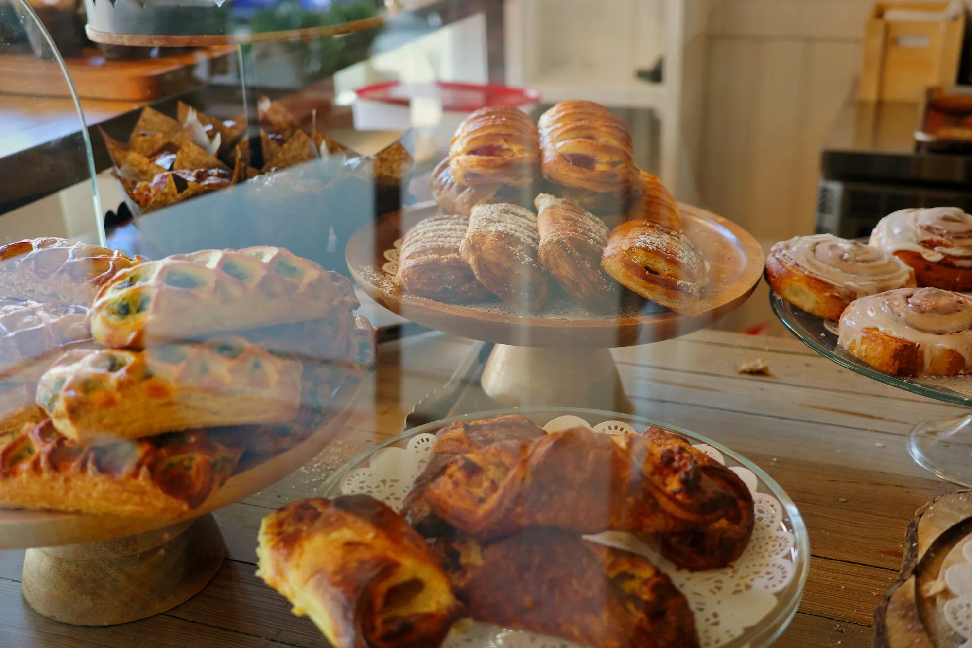 Croissants, danishes and cinnamon buns on wooden stands