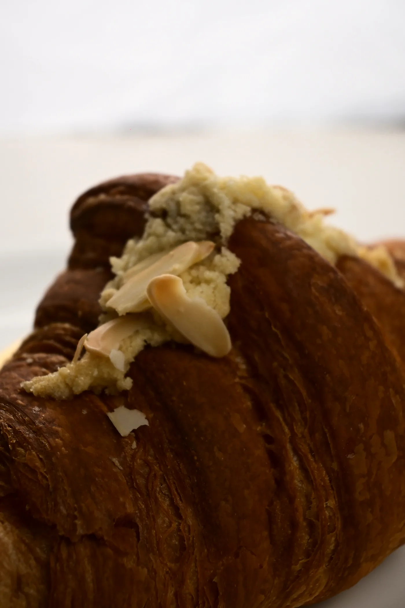 A croissant filled with pistachio cream and scattered with flaked almonds