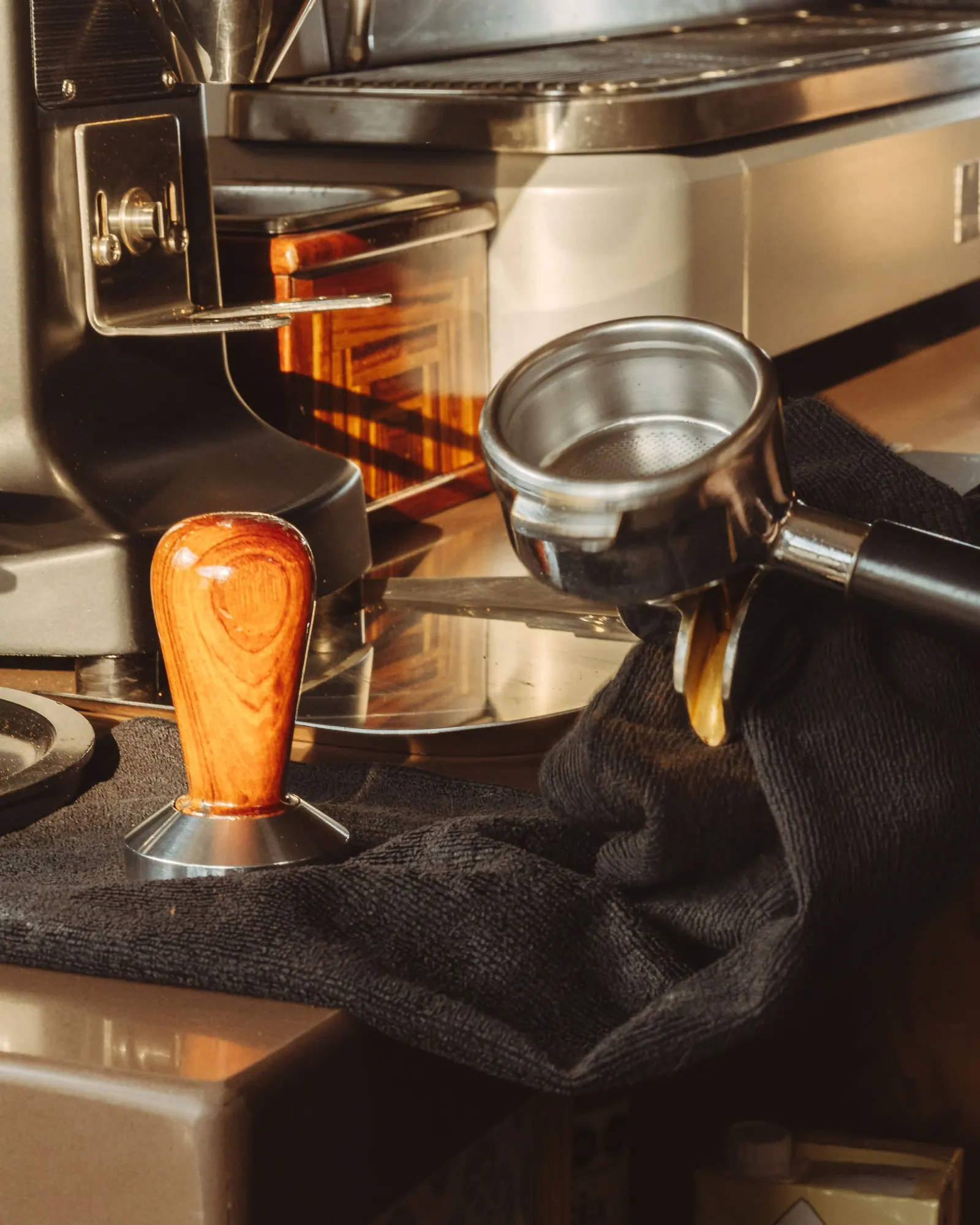 Espresso extracting from a portafilter on a café counter