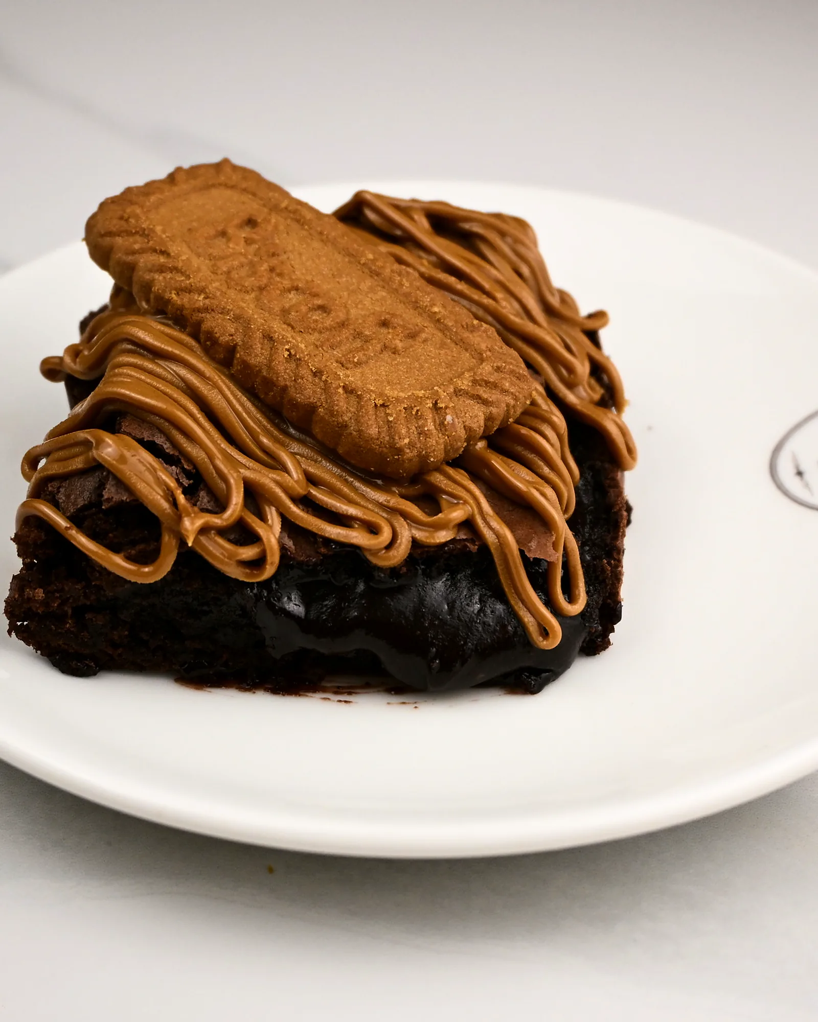 A brownie piped with Biscoff and finished with a Biscoff biscuit